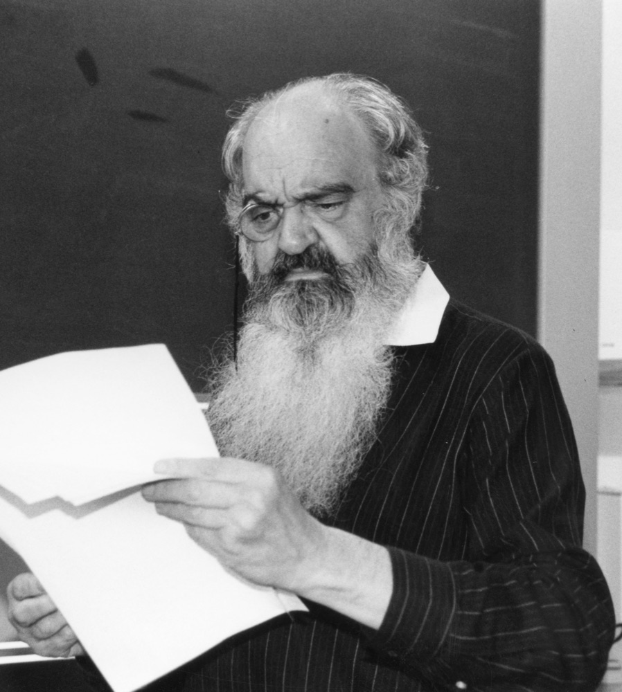 Stafford Beer in 1990, white-bearded, reading a sheet of paper